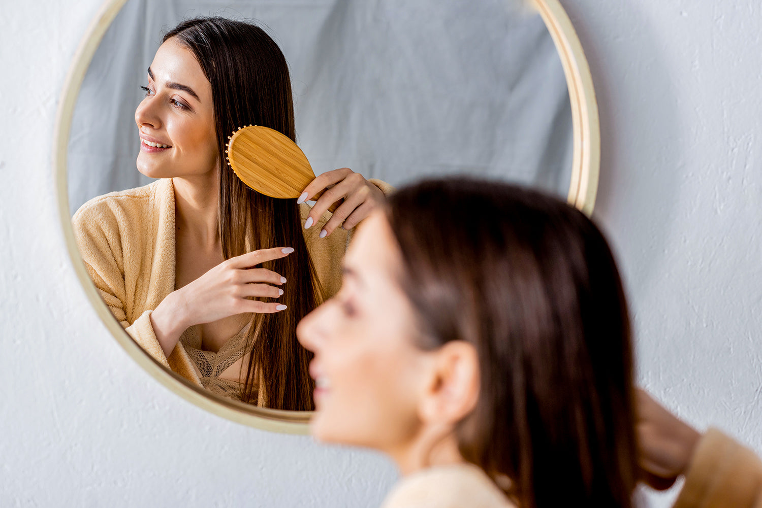An adult woman brushes her hair
